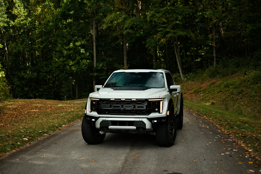 Ford F-150 Raptor on a wooded road in Asheville